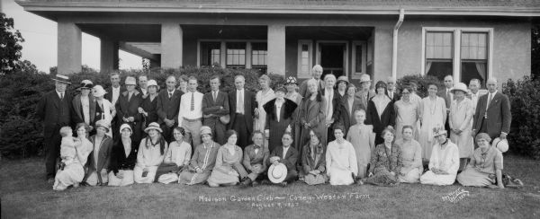 Group portrait of men, women, and a young child, members of the Madison Garden Club, in front of the Coney Weston farmhouse, 5017 Odana Road.