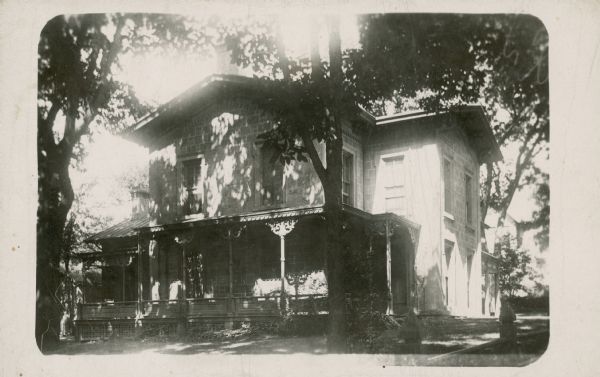 Photographic postcard of the N. B. Van Slyke residence . Constructed of stone.