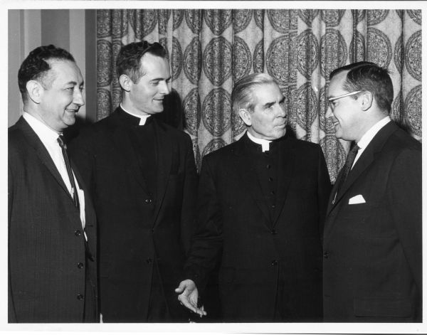 Minow poses with three men at a breakfast of the Catholic Apostolate of Mass Media.