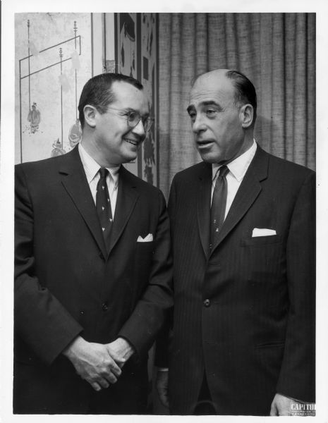 Newton Minow, left, stands posing next to an unidentified man.