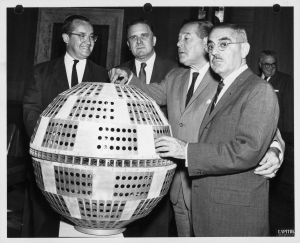 Newton Minow (left) and three men of the Senate Commerce Communications Subcommittee look at a model of the Telstar satellite.
