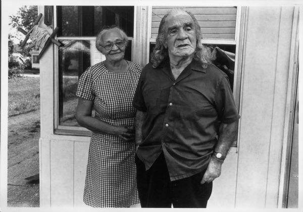 Rubie and Frank Bond standing together outdoors in front of a building.