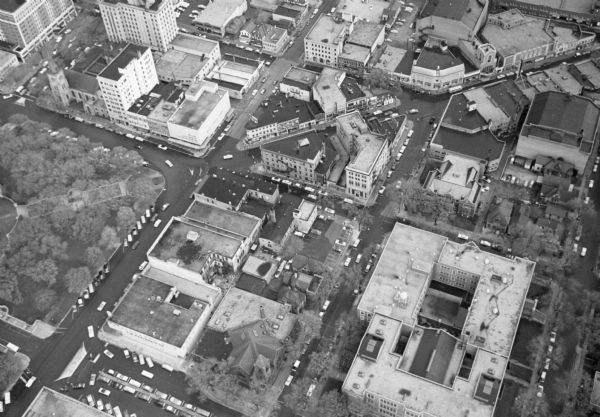 Aerial view of Madison, including the Capitol Square on the left at Mifflin and State Street, and Central High School, the light-colored building in the foreground on the right.