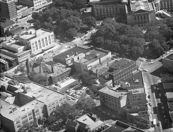 Aerial view of the Capitol Square, with Capitol Park and part of the Wisconsin State Capitol. Manchester's is on the corner of Mifflin Street at Wisconsin Avenue, and Mifflin, Carroll, and State streets meet on the right.