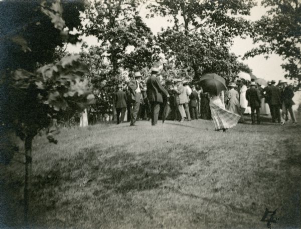 Group of people standing on an eagle effigy mound on State Hospital grounds.