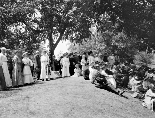 People gathered for a ceremony at the unveiling of a marker at an eagle effigy mound on the State Hospital Grounds.