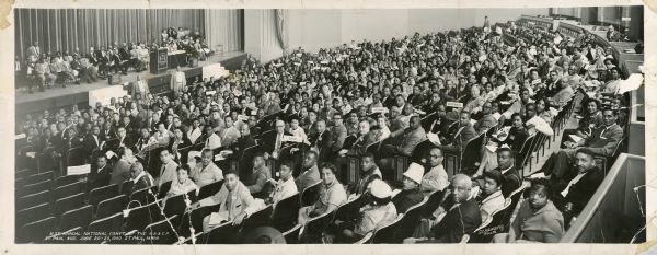 Group portrait of attendees at the 51st annual national convention of the National Association for the Advancement of Colored People, in the St. Paul Auditorium in St. Paul, Minnesota. Among the state delegations visible are Kentucky, Ohio, Indiana, Wisconsin, and Virginia.