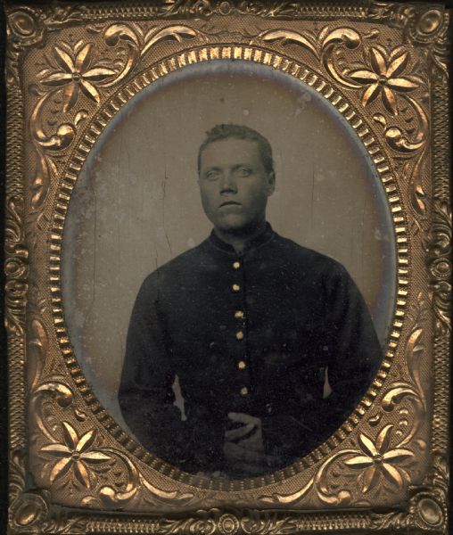 Tintype/ferrotype waist-up portrait of Knudt Johnson of the Dodgeville Guards, later known as Company C, 12th Regiment, Wisconsin Volunteer Infantry. Gold details on buttons of jacket.