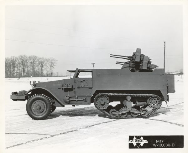 View of the left side of an International Harvester half-track M17 parked outdoors.