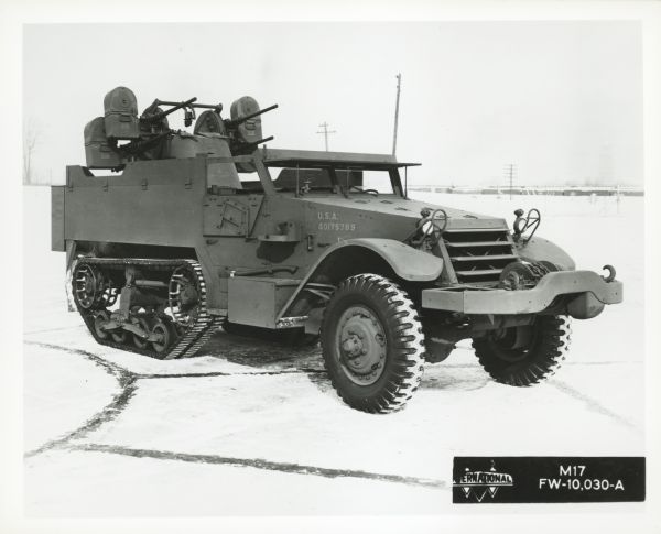 Three-quarter view from front right of an International Harvester half-track M17 parked outdoors.