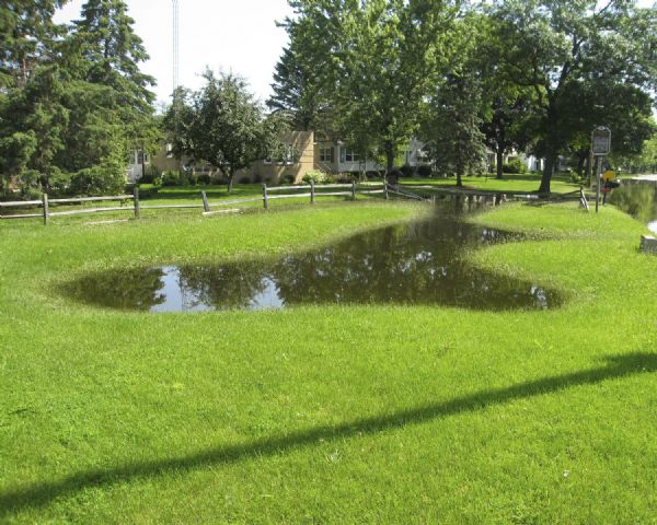 View looking east of a 1000-year-old Indian intaglio effigy in the shape of a panther. The effigy, which is on the north bank of the Rock River, is filled with water due to flooding.