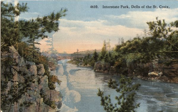 Postcard of the Interstate Park, located on the St. Croix River at St. Croix Falls, Wisconsin, and Taylors Falls, Minnesota. This is postcard 4610 in a series by E.A. Bishop of Racine. The postcard caption reads: "The beautiful Dells of the St. Croix River which form the main attraction of our interstate Park are now spanned by a very substantial bridge, permitting visitors to tour either side of this wonderland of rock and scenic beauty. Most beautiful and instructive indeed is the view we obtain from the top of the lofty ledges."