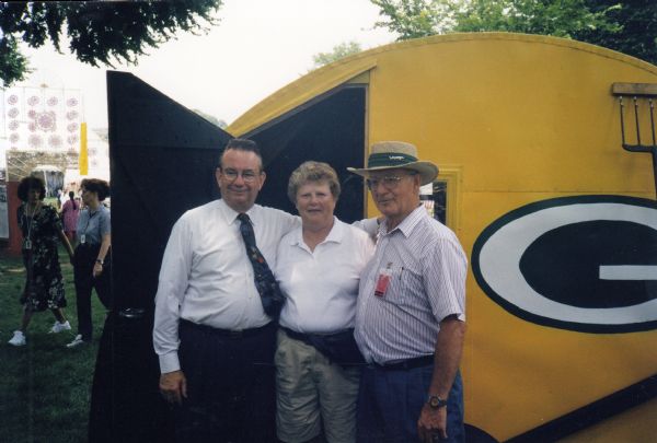 Group portrait of Bill Casper (right) and his wife, Kathy, with Wisconsin Governor Tommy Thompson at the 1998 Smithsonian Folklife Festival on the National Mall in Washington, D.C., where Casper’s iconic Green Bay Packers ice shanty was on display. 