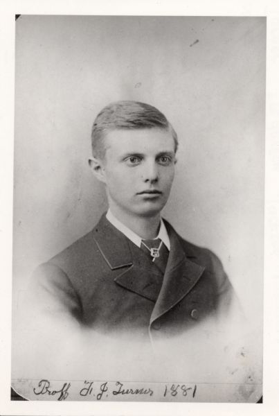 Quarter-length portrait of Frederick Jackson Turner in his sophomore year at the University of Wisconsin. He wears a Kappa Psi Phi pin on his tie.