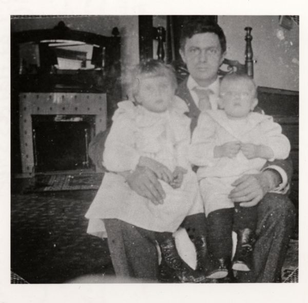 Frederick Jackson Turner holding his two children, Dorothy and Jackson Allen Turner and in their Frances Street home.