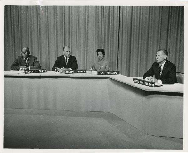 Still from an episode of the WTMJ program "Human Rights," which was titled "Race Relations '66." Four people: Wesley L. Scott, executive director of the Milwaukee Urban League; Joseph C. Fagan, chairman of the Industrial Commission of Wisconsin; Vel Phillips, alderman for Milwaukee's 6th Ward; and Judge Max Raskin, program moderator.