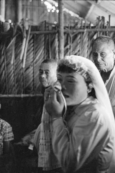 Anh Le Vuong weeps at her wedding to Tien Vinh Le in Binh Hung, Vietnam. Two men are standing behind her.