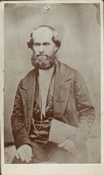 Three-quarter length sitting portrait of James Strang.