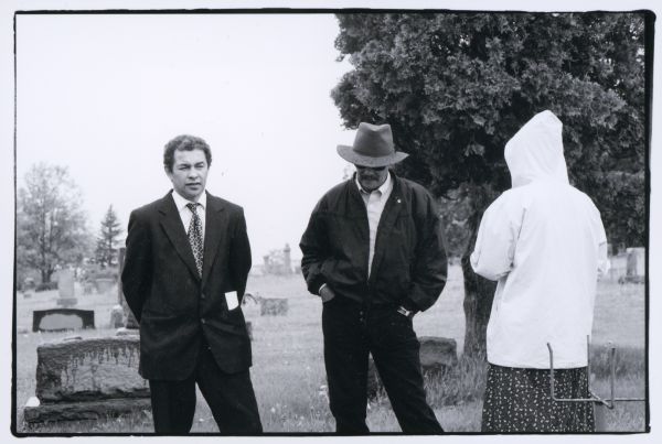 From left to right are Craig Arms, Lewis Arms, Jr., and with her back to the camera, Jenny (Arms) Blair, daughter of Lewis Arms, Jr.. They are at Forest Hill cemetery to attend the funeral of Blanche Arms.
