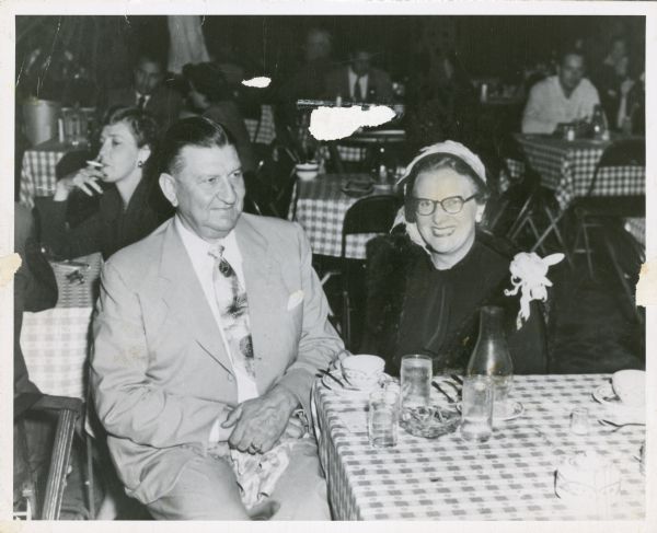 Karl H. Fauerbach and his wife Mildred Fauerbach are seated at a table in a restaurant during a trip to Cuba. 