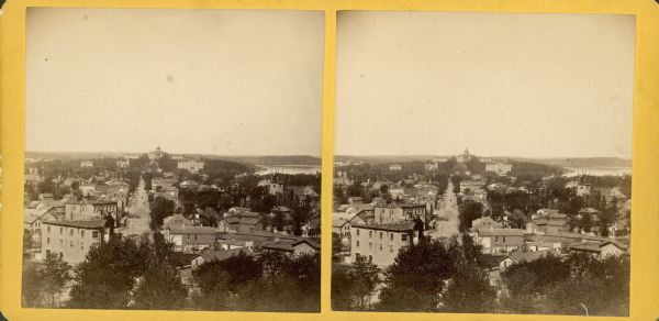 A stereograph view from University Hill (later called Bascom Hill) including University of Wisconsin buildings, State Street, and the Wisconsin State Capitol.