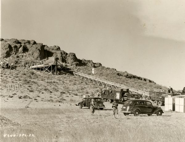 A long ramp on the side of hill on the outdoor set for the film "Wuthering Heights." The ramp leads to a rocky outcropping. Several cars and trucks are in the foreground.