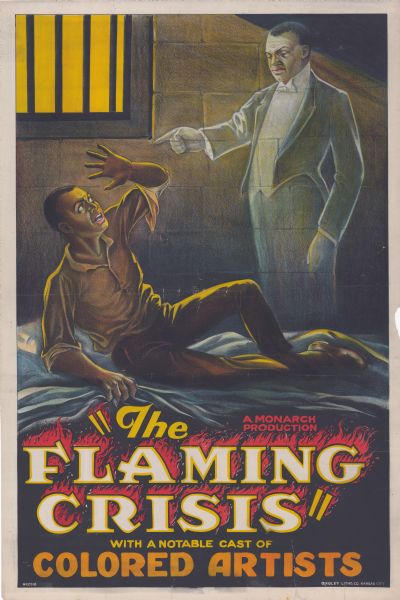 Poster for the film "The Flaming Crisis." A is man laying on a cot in a jail with his hand raised to protect himself. Standing near the cot is a ghost wearing a tuxedo who is pointing at the man.
