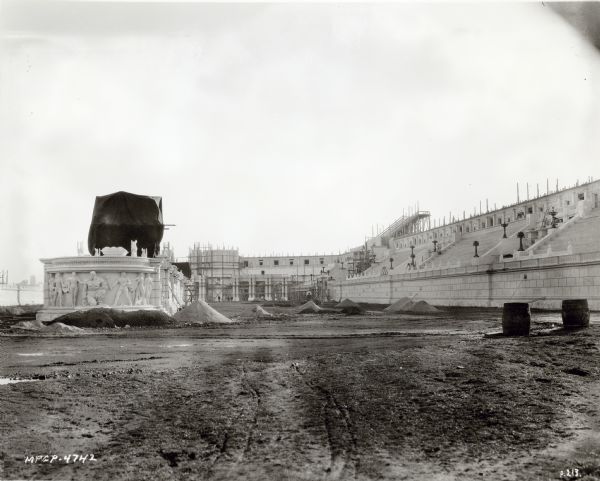A view of the Circus Maximus set under construction for the 1925 film "Ben-Hur: A Tale of the Christ." Scaffolding and piles of dirt are around the set.
