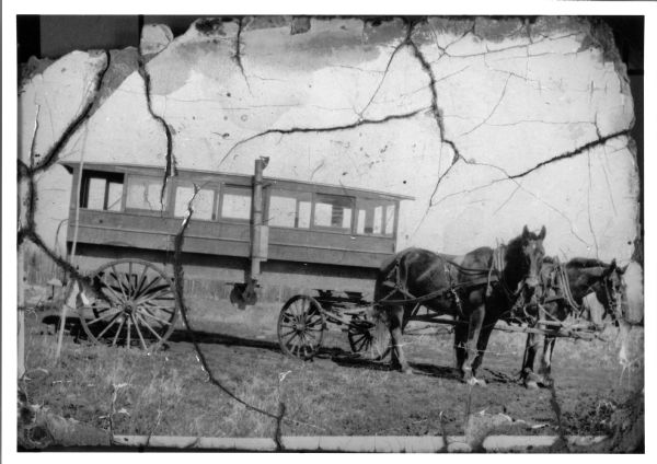 A school bus pulled by a team of horses named Colonel and Ned.