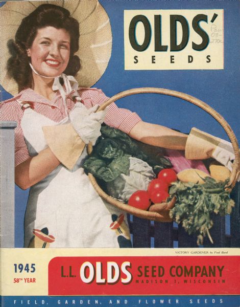 A cover design of the Olds' Seeds catalog from the L.L. Olds Seed Co. The caption reads: "Victory Gardener by ???," and features a photograph of a woman wearing a dress, blouse, hat and gardening gloves holding a basket of vegetables from her victory garden.