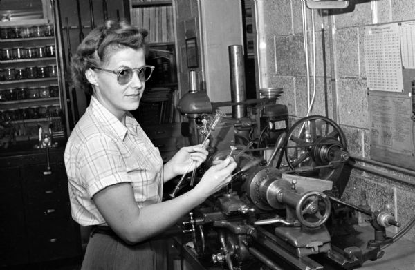 Wilma Erway working at the lathe in a glassblowing studio.