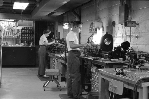 Wilma and Norman Erway working in their glassblowing shop.