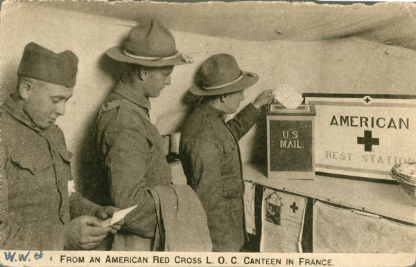 Soldiers mailing letters home at the Red Cross L.O.C. canteen in France.