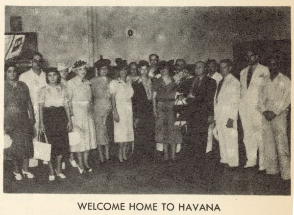 Henry Weiner, United Artists manager in Cuba, is greeted by staff and friends upon his return to Havana after a three week vacation in New York with his wife. 