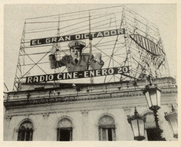 A movie theater marquee on top of a building in Havana advertising Charlie Chaplin's film "The Dictator." The caption below the photograph reads: "HAVANA — A shining mark on the marquee."