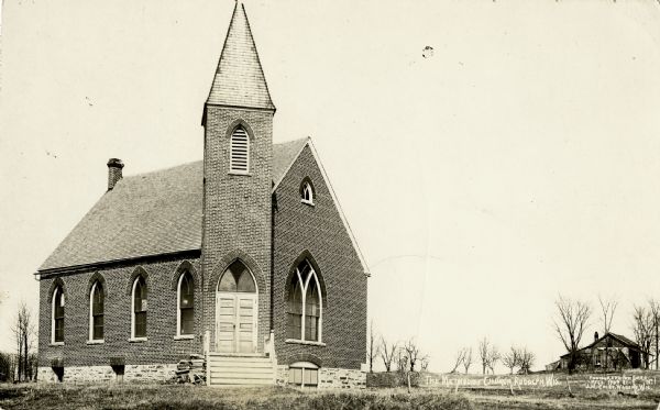 Exterior of Methodist church. A house is in the distance on the right.