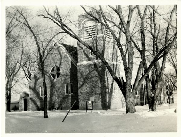 Exterior view of the First Congregational Church, with bell tower. Snow is on the ground.