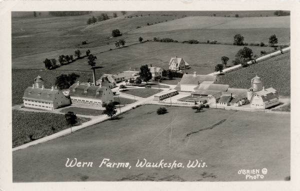 Aerial view of a farm complex, including a farmhouse and several large buildings. Caption reads: "Wern Farms, Waukesha, Wis."