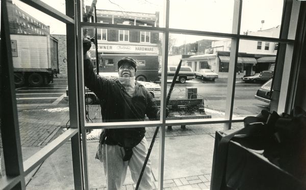 View looking out window at a man who is washing the window. Caption reads: "Edgar Gordon spreads cleanliness and happiness."

Edgar William Gordon was a window cleaner in Milwaukee, and he played alto horn in the First Brigade Civil War band. He made a lifelong mission out of encouraging positive interaction between white and black members of the community. He died in 1997.