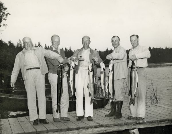 Dwight D. Eisenhower and his brothers on a fishing trip proudly exhibiting muskies and northern pike on a Wisconsin lake. From left are Dwight, Edgar, Milton, and Roy Eisenhower.