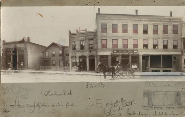 View across State Street towards commercial buildings, including the Christian Dick Wholesale Wine & Liquor Dealer to the Eureka Billiard Hall and Bowling Ally. Men are standing outside of the storefronts. Another man is sitting in a horse-drawn cart which is advertising Christian Dick's store. Notes below the photograph describe the numerous alterations to the image. The windows above the liquor store are painted in, and the large window to the right of Christian Dick is an illustration attached on top of the photograph. Parts of the other buildings to the left of Christian Dick are blurred out, blacked out, or illustrated.