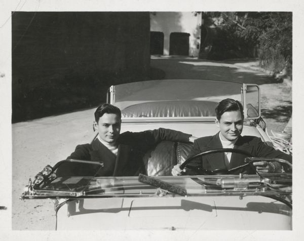 Paal and Leif Rock, twin brothers from Norway, sitting in the front seat of a car. The pair, also known as the Rocky Twins, were dancers and drag queens in the 1920s and 1930s.