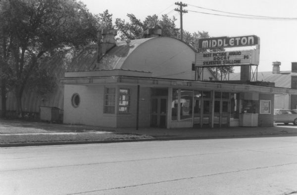 View across street towards the Middleton movie theater, a Quonset hut-style building on the east side of Parmenter Street between North and Franklin Streets.