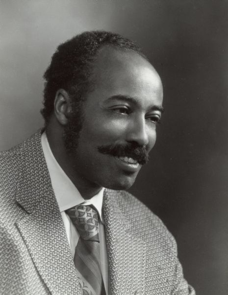 Quarter-length portrait of E. Gordon Young, an attorney and civil rights activist who became the state's first black assistant attorney general in 1965. At the time he was also president of the state chapter of the NAACP. Young has a long career both with the NAACP and as a lawyer in Madison.