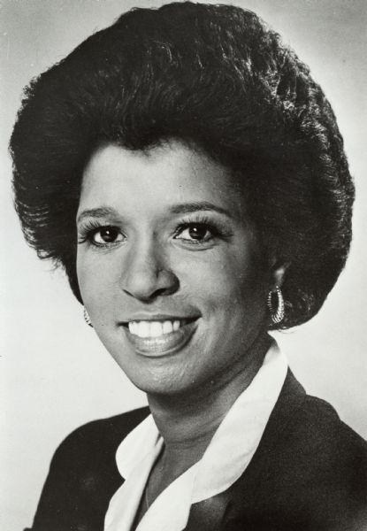Head and shoulders portrait of Pam Johnson, who in 1981 became the publisher for the "Ithaca Journal." This made her the first black woman to become publisher for a general-circulation newspaper in the United States. Ms. Johnson earned doctorates in journalism and educational psychology from the University of Wisconsin in 1963. She worked as a reporter for the "Chicago Tribune," and then moved back to Wisconsin, where she worked as a reporter for a Madison radio station and taught at the University.