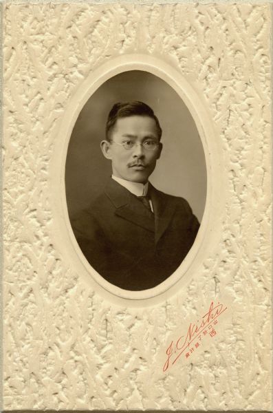 Quarter-length portrait of a young man, identified as Mioro Yamamoto. Yamamoto was a Japanese international student at the University of Wisconsin-Madison; in 1907 he was a member of the campus' International Club. He knew and might have been a student of Richard T. Ely's.