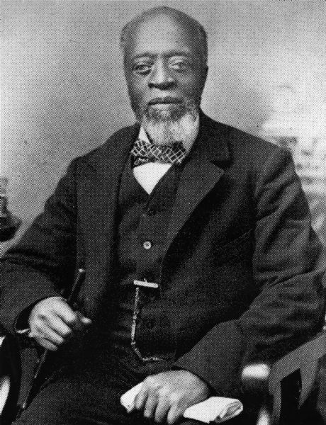 Portrait of Solomon Freeman wearing a suit and sitting in a chair. Solomon Freeman was a slave purchased by Abraham Bush as a boy. The Bush family moved to what would become Middleton in 1847, and granted freedom to Solomon and his mother, though both remained with the Bush family as servants. They lived in a log cabin in Section 2 of the Town of Middleton, near the present-day intersection of Century Avenue and Highway 12 and 13.

Solomon later assisted John Green in a grain mill and wool business. He lead the Baptist Union Church congregation when their regular minister was unable to be there. He died in 1900 and is buried in Middleton Junction Cemetery. His grave was unmarked until 1974, when the Middleton Historical Society put up a marker.