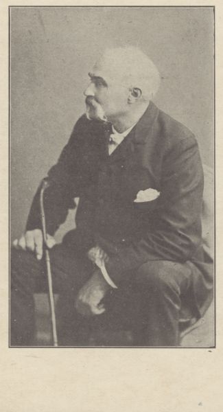 Portrait of Charles Doty sitting and holding a cane.