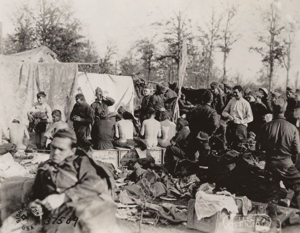 U.S. soldiers from the 125th Regiment Infantry (composed of detachments from the 31st and 33rd Regiment Infantry, Michigan National Guards) and the 32nd Division ("Red Arrow Division") at a delousing station near Montfaucon, Meuse, France.