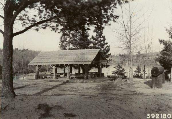 Caption reads: "Shelter, pump, and carving log at Wanoka Camp Ground on the Chequamegon National Forest."